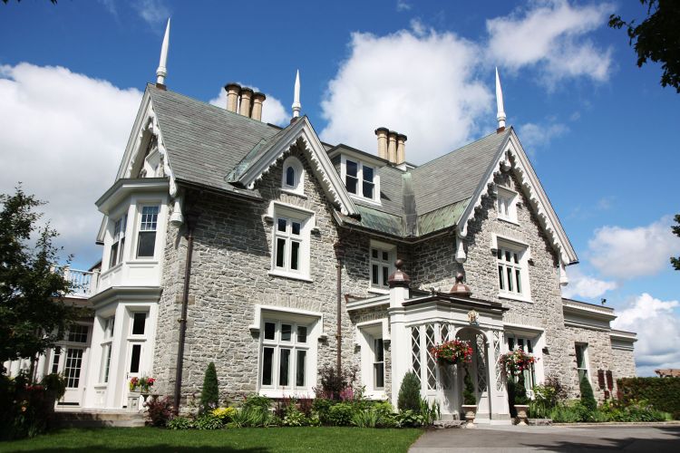 Exterior view of the two-storey Victorian stone home.